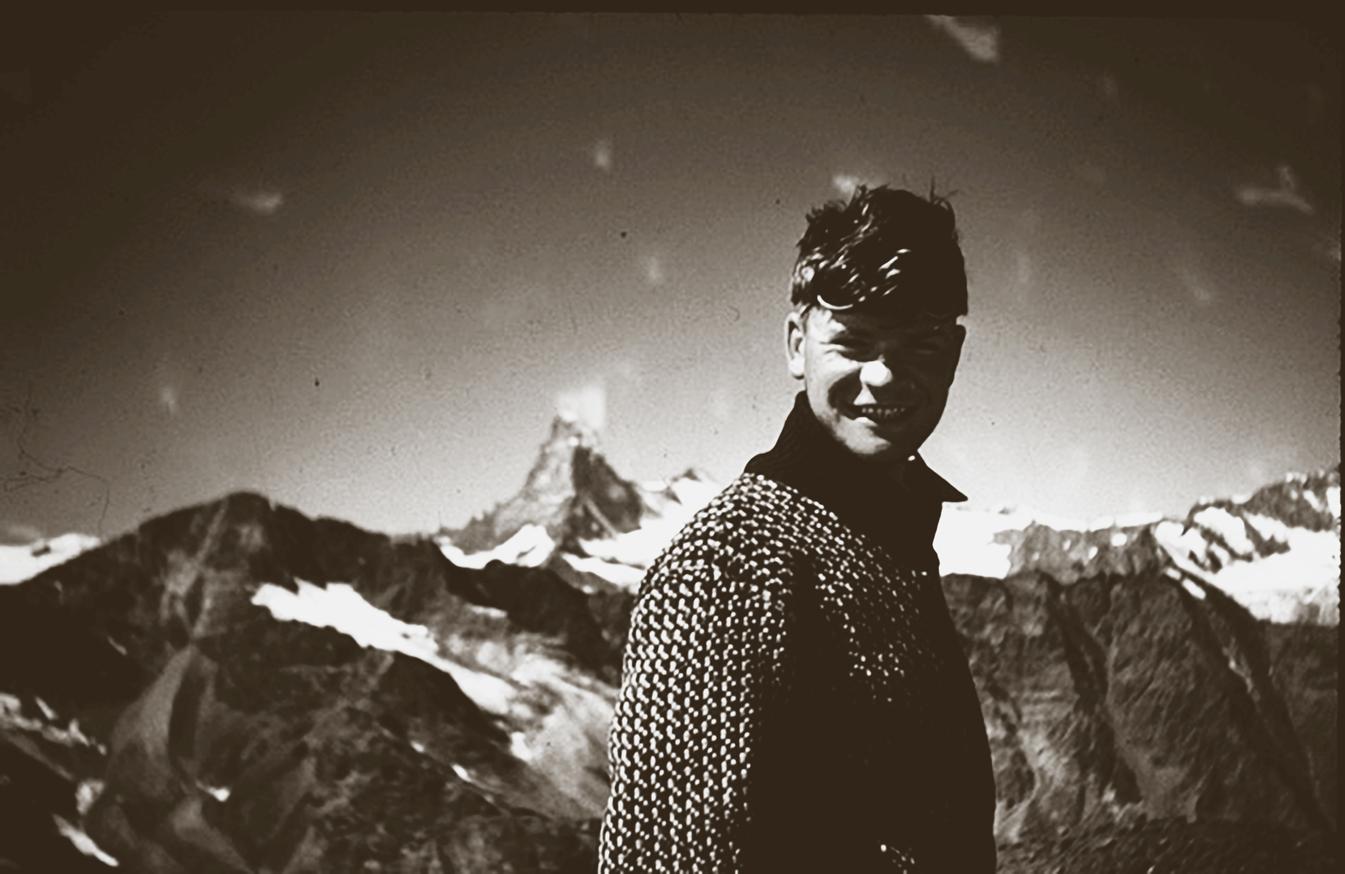Man standing with mountains in background