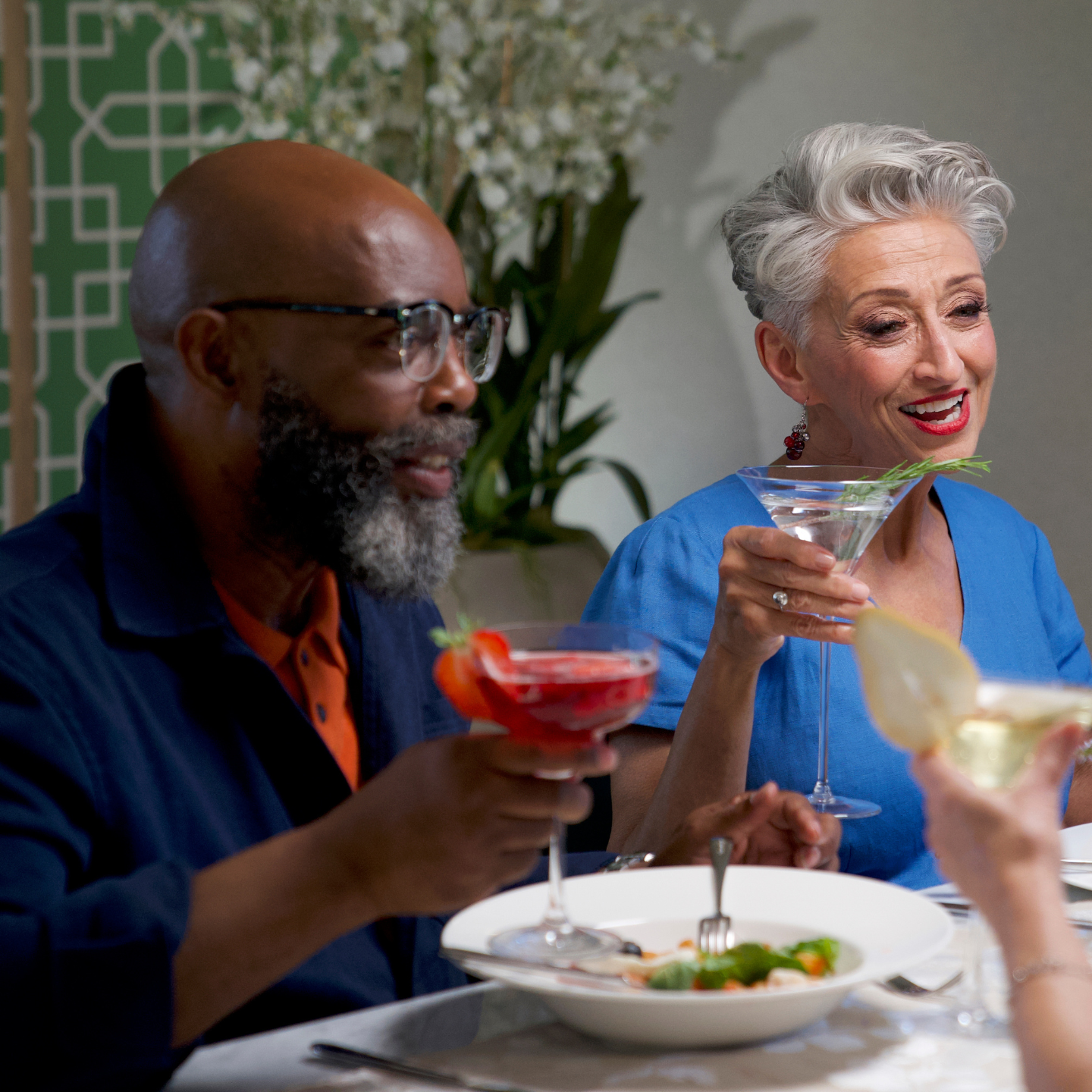 Two people holding drinks