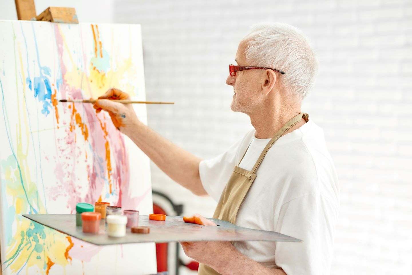 Elderly man painting