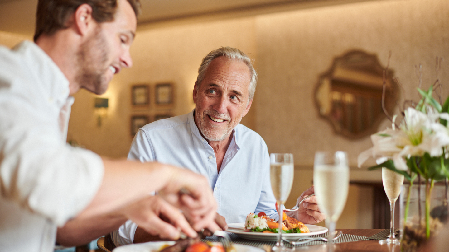 Two people sat eating dinner