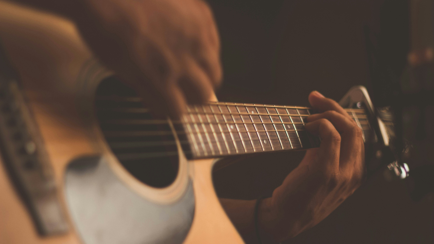 Someone playing the guitar