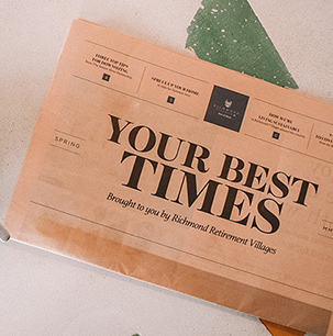 Pink newspaper on brightly coloured table with coffee