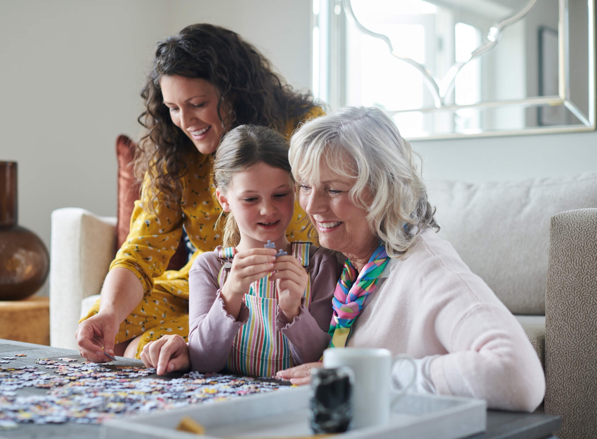 Picture of a family enjoying making a jigsaw and spending quality time together