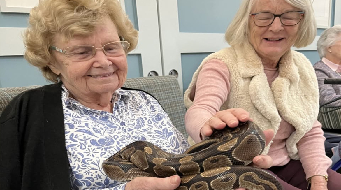 Residents Holding a Snake