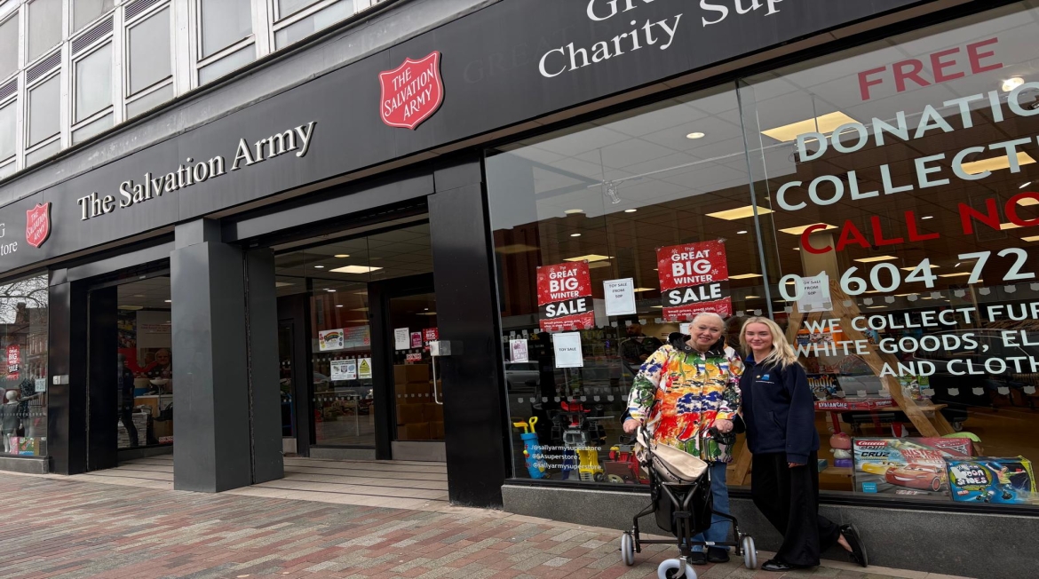 Two people standing outside the Salvation Army Shop