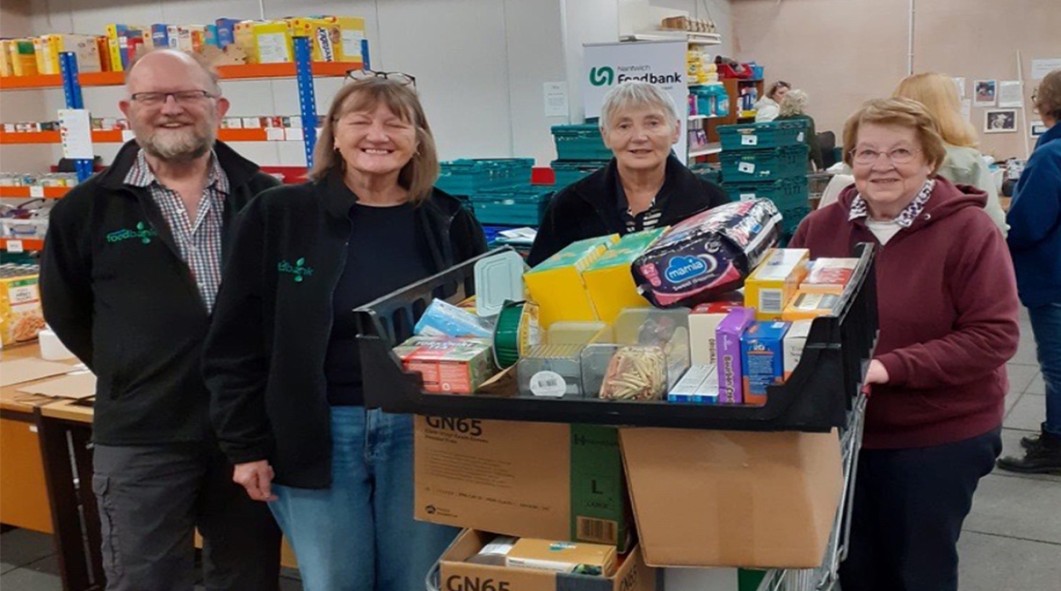 Richmond Villages Nantwich Celebrates Harvest With Community Foodbank Drive Four people standing by a trolley filled with food