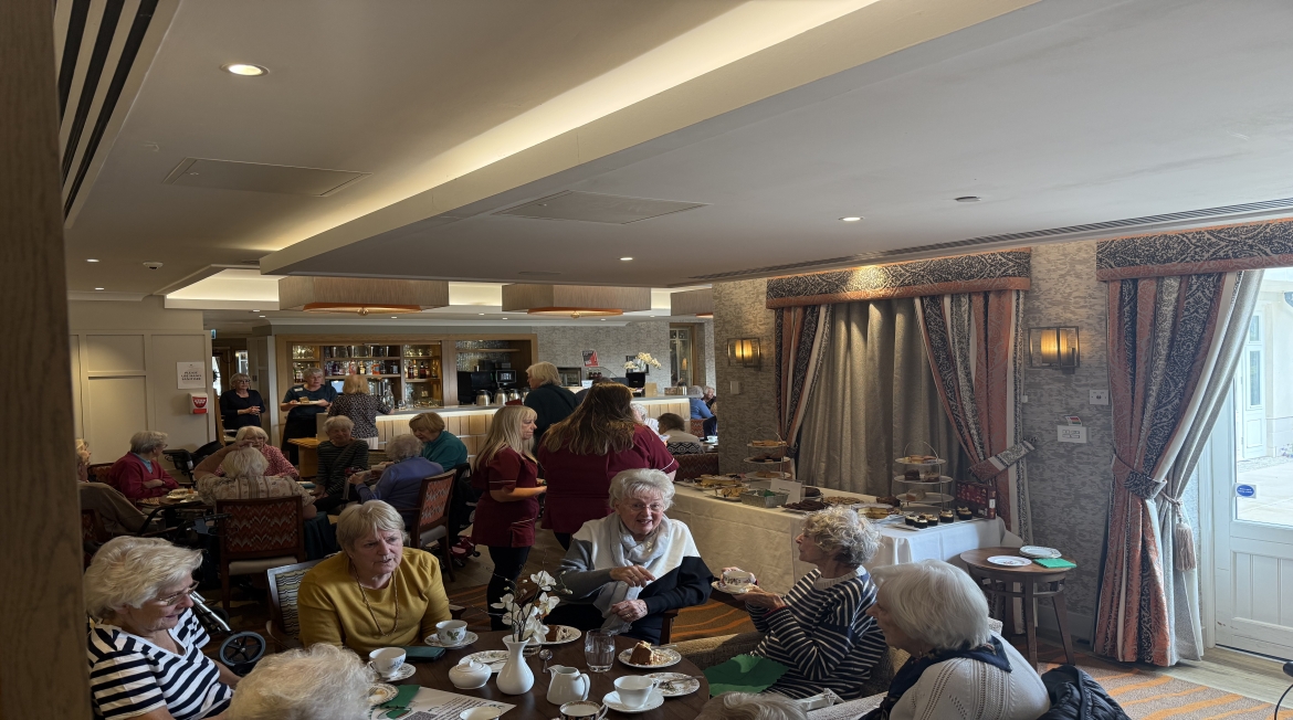 Richmond Villages Witney Hosts Coffee Morning For Charity People gathered round tables with coffee and cakes