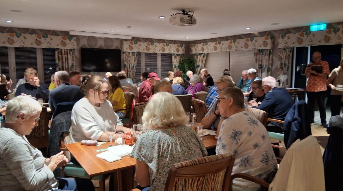 A busy room sitting at tables
