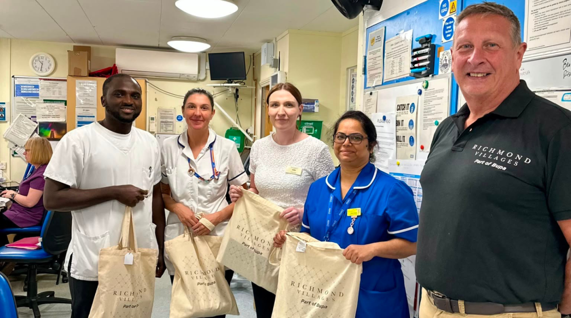 Nurses smiling while holding tote bags