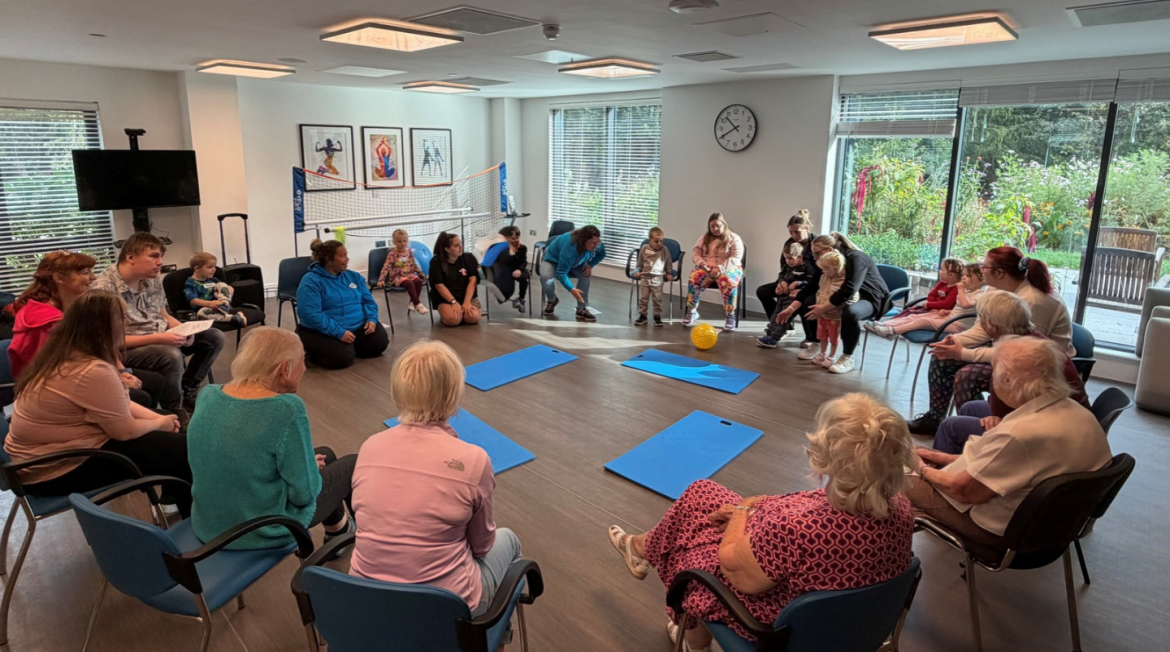 People sitting in a circle in a gym studio