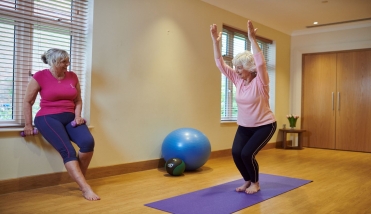 Two ladies doing yoga