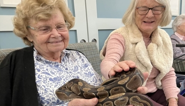 Residents Holding a Snake