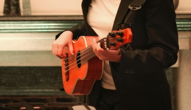 A person holding a ukulele