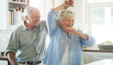 Senior couple dancing in kitchen