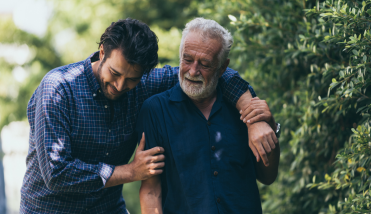 Senior man and son walking outside