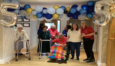 People standing under balloons