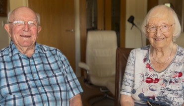 A couple smiling at the camera