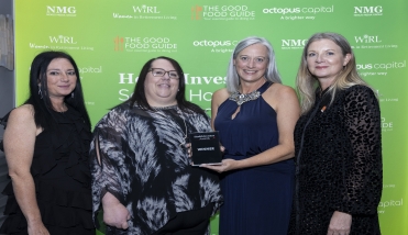 Four people holding an award