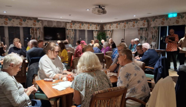 A busy room sitting at tables