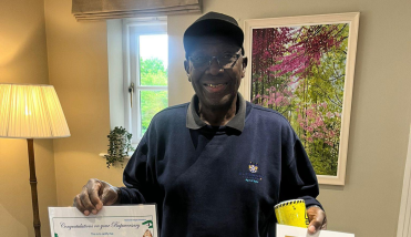 A man holding a certificate