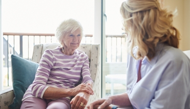 Two people sitting looking at each other