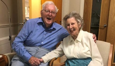 ELDERLY COUPLE SMILING HOLDING HANDS