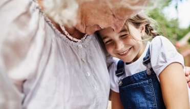 Elderly lady hugs grandaughter