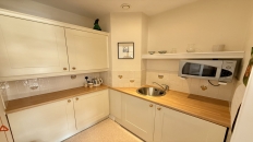 Kitchenette with white cupboards